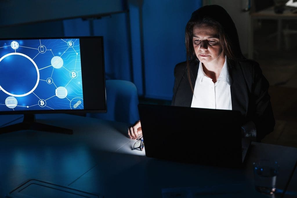 Business trader woman working at night inside fintech company office doing blockchain research - Focus screen